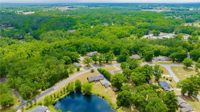 drone / aerial view with a view of trees and a water view