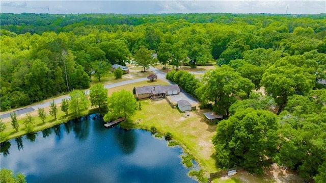 drone / aerial view featuring a view of trees and a water view
