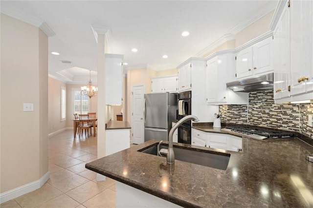 kitchen with white cabinetry, sink, ornamental molding, and kitchen peninsula