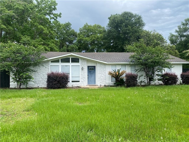 9424 Johnson Rd S, Mobile, AL 36695 - view of front of house with stone siding, roof with shingles, and a front lawn