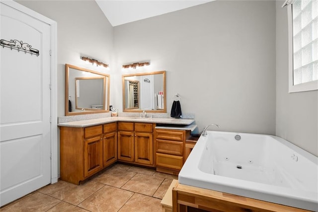 bathroom featuring tile patterned floors, vanity, and a tub