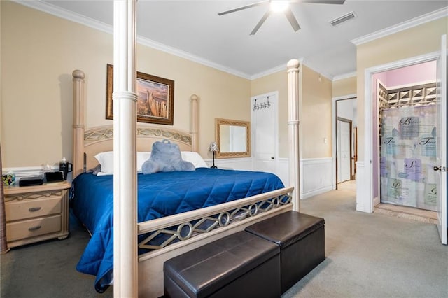 bedroom featuring ornamental molding, a closet, ceiling fan, and carpet