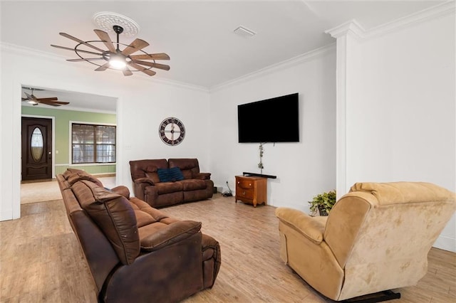 living room featuring ornamental molding, ceiling fan, and light wood-type flooring