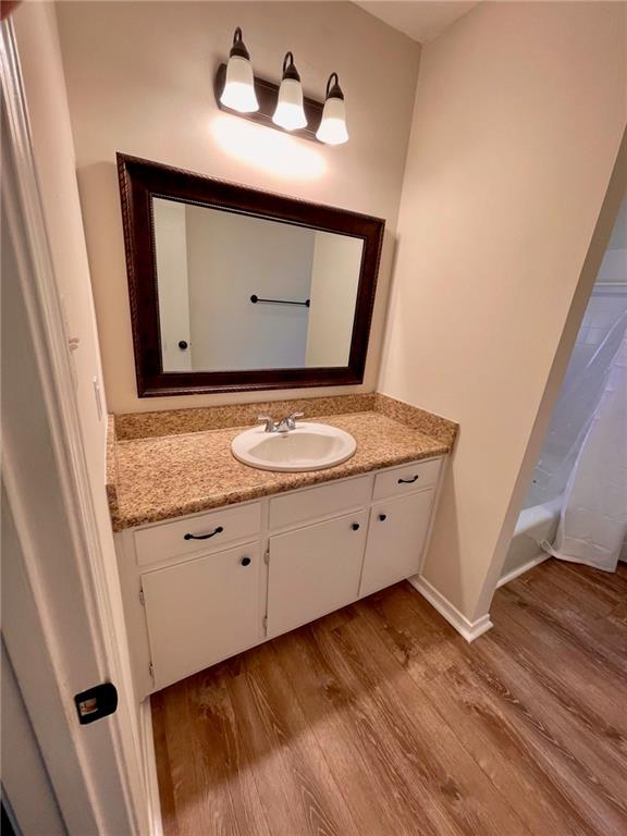 bathroom featuring vanity and hardwood / wood-style flooring