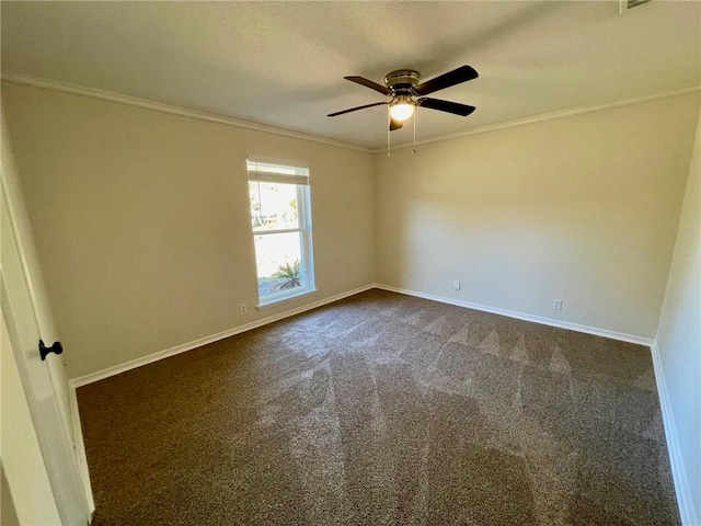 empty room with ornamental molding, ceiling fan, and dark colored carpet