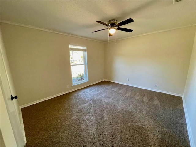 empty room with crown molding, a ceiling fan, baseboards, and dark colored carpet