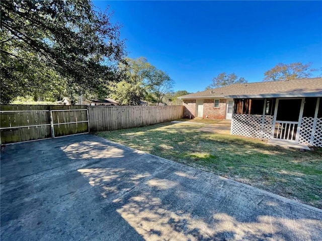 view of yard with fence and a patio