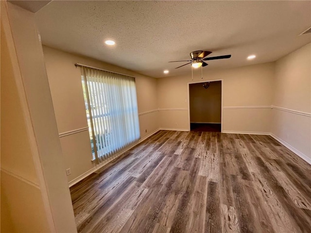 empty room with a textured ceiling, wood-type flooring, and ceiling fan