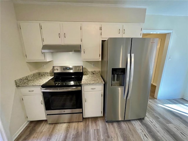 kitchen featuring white cabinetry, light stone countertops, appliances with stainless steel finishes, and light wood-type flooring