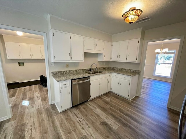 kitchen featuring visible vents, stainless steel dishwasher, wood finished floors, a sink, and white cabinets