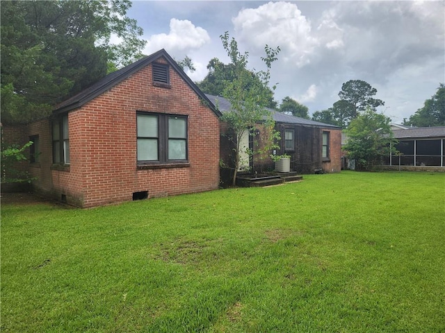 rear view of property with a yard