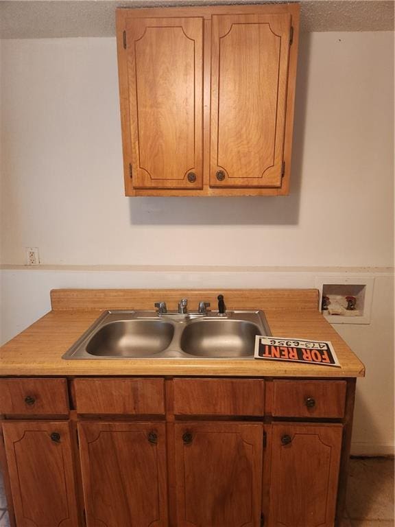 kitchen with sink and a textured ceiling