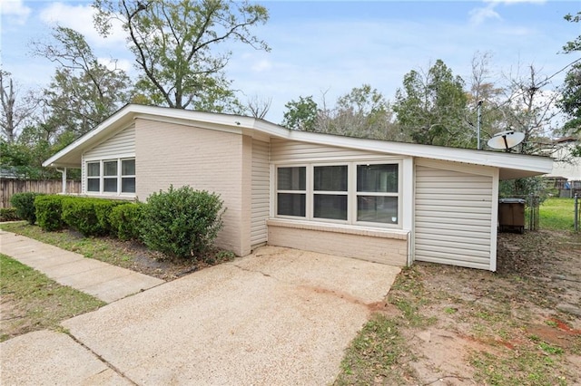 exterior space with brick siding and fence