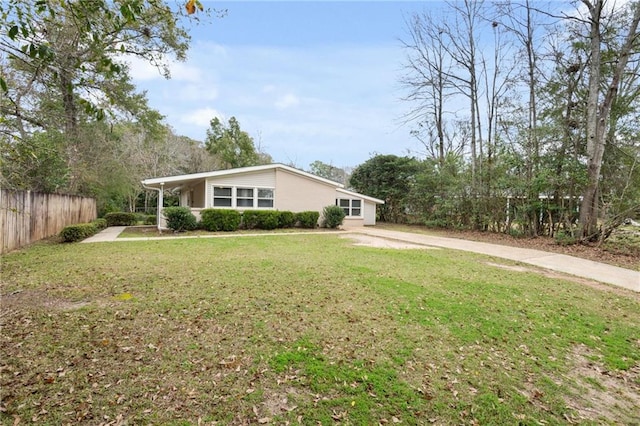 exterior space with fence and a front lawn