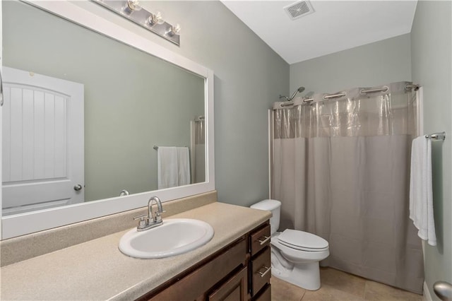 bathroom with a shower with curtain, vanity, tile patterned floors, and toilet