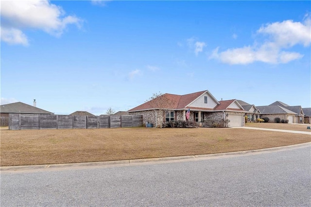 single story home featuring a garage and a front lawn