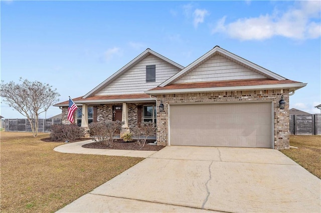 craftsman inspired home featuring a garage and a front lawn