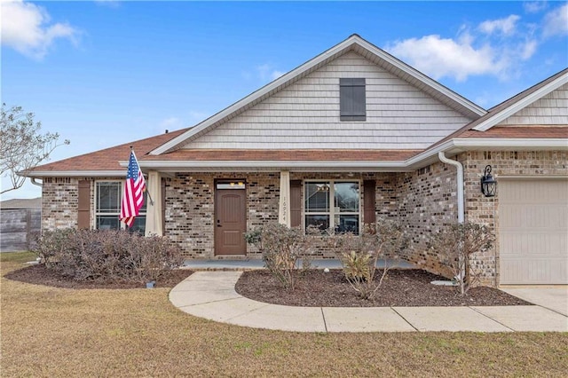 view of front of house with a garage, a front lawn, and a porch