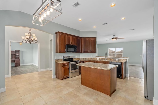 kitchen with ceiling fan with notable chandelier, a center island, black appliances, decorative light fixtures, and kitchen peninsula