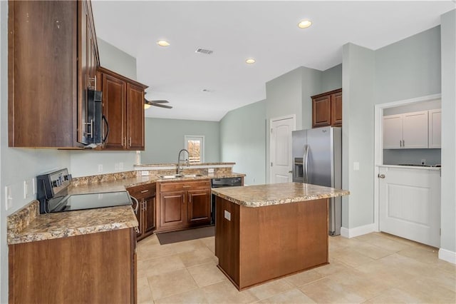 kitchen with sink, ceiling fan, stainless steel appliances, a center island, and kitchen peninsula