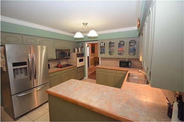 kitchen with black appliances, kitchen peninsula, backsplash, sink, and light tile floors