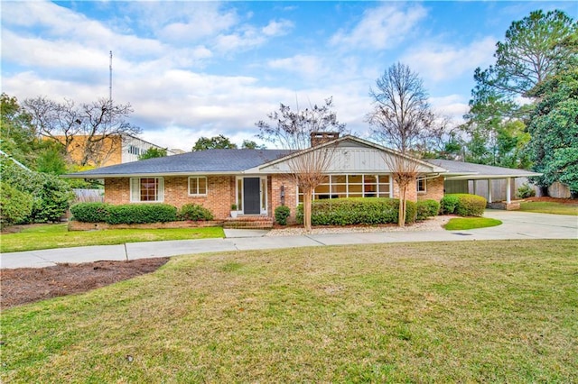 single story home with a front yard and a carport