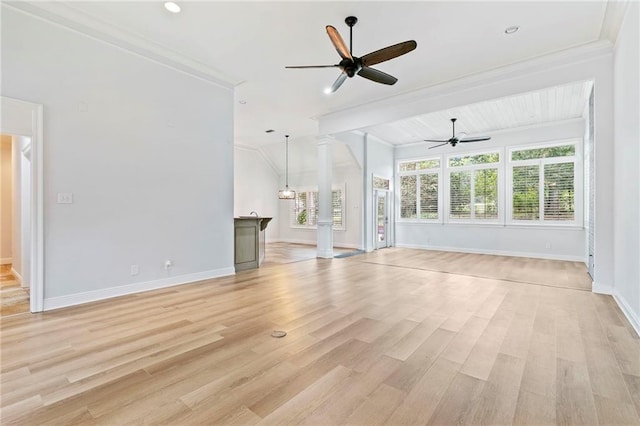 unfurnished living room with beamed ceiling, light hardwood / wood-style flooring, ornamental molding, ceiling fan, and ornate columns