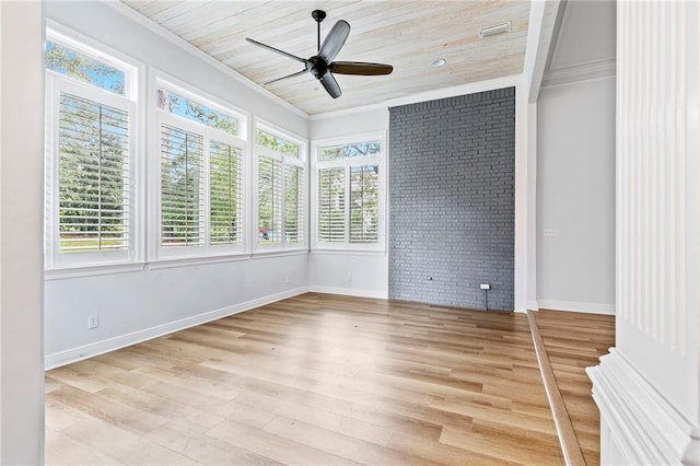 spare room with ceiling fan, wood ceiling, brick wall, light hardwood / wood-style flooring, and crown molding