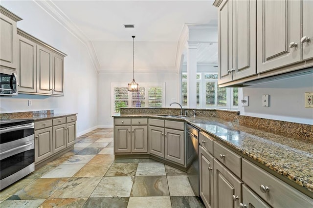 kitchen featuring appliances with stainless steel finishes, hanging light fixtures, crown molding, dark stone counters, and sink