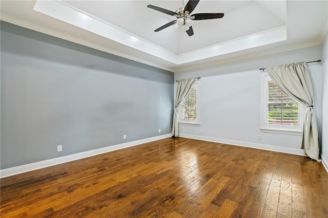 unfurnished room with crown molding, a tray ceiling, ceiling fan, and hardwood / wood-style flooring