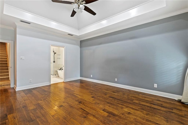 unfurnished bedroom with dark hardwood / wood-style flooring, ensuite bath, a raised ceiling, crown molding, and ceiling fan