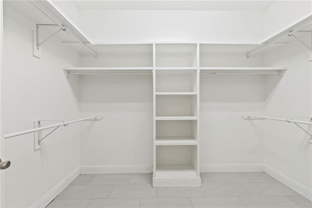 spacious closet featuring tile patterned flooring