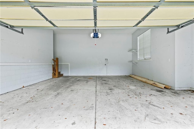 garage featuring a garage door opener and a carport