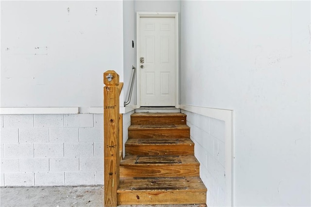 stairway featuring concrete floors