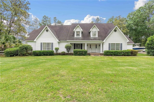 new england style home featuring a front lawn