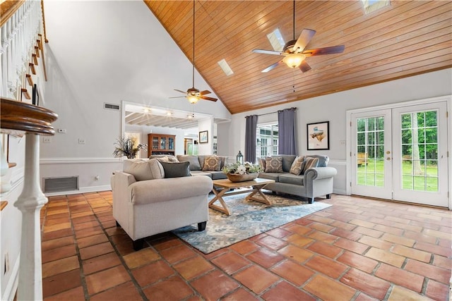 living room featuring french doors, wood ceiling, dark tile patterned floors, ceiling fan, and high vaulted ceiling