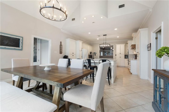 dining space with ornamental molding, sink, light tile patterned floors, high vaulted ceiling, and an inviting chandelier