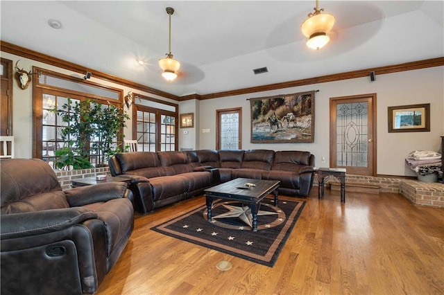 living room featuring plenty of natural light, light hardwood / wood-style floors, crown molding, and ceiling fan