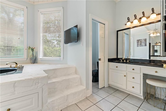 bathroom with tile patterned floors, ceiling fan, and vanity