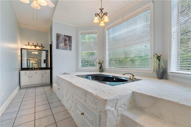 bathroom featuring tile patterned floors, vanity, a wealth of natural light, and an inviting chandelier