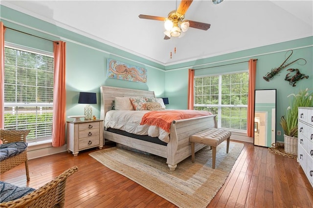 bedroom with multiple windows, ceiling fan, and hardwood / wood-style flooring