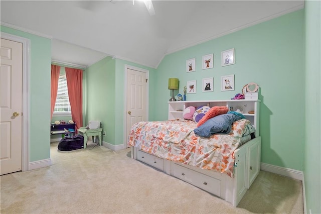 carpeted bedroom featuring ceiling fan, ornamental molding, and vaulted ceiling