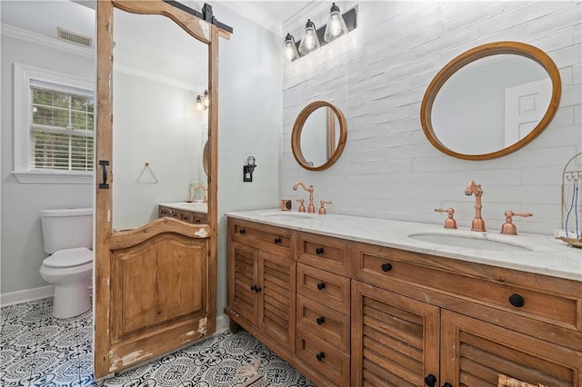 bathroom with tile patterned flooring, vanity, toilet, and ornamental molding