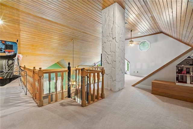 staircase featuring carpet floors, vaulted ceiling, ceiling fan, and plenty of natural light