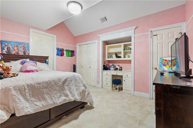 carpeted bedroom with lofted ceiling