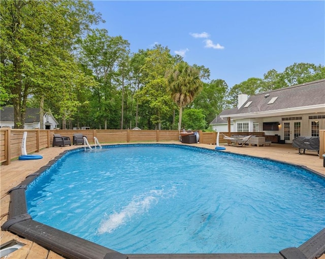 view of swimming pool featuring french doors