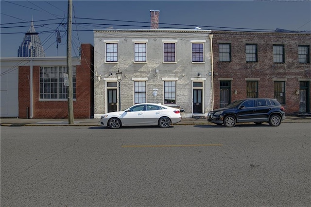 multi unit property featuring brick siding and a chimney