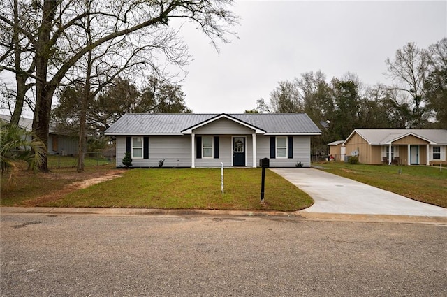 13474 Rooster Ln, Foley, AL 36535 - single story home featuring concrete driveway, metal roof, a front yard, and fence