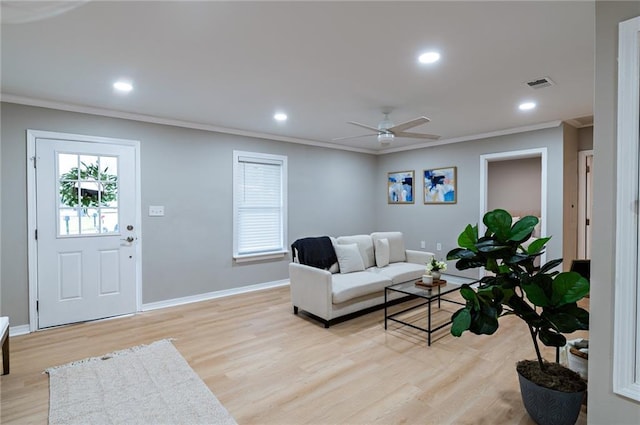 living room featuring recessed lighting, light wood-type flooring, baseboards, and ornamental molding