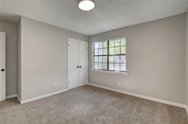1112 Druid Dr, Mobile, AL 36618 - unfurnished bedroom featuring carpet, a textured ceiling, baseboards, and a closet